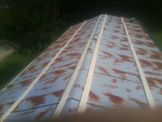 Rusted metal roof panels with new wood purlins before replacement — Storm Damage Roof Repair in Jobstown by Roofing Brothers