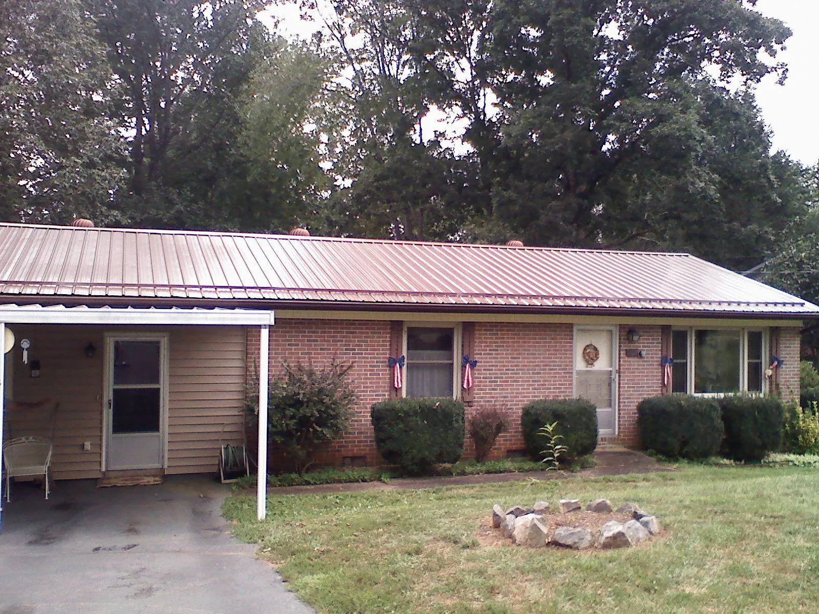 Bronze metal roof and carport on a brick ranch home — Roof Repair work by our crew in Jobstown